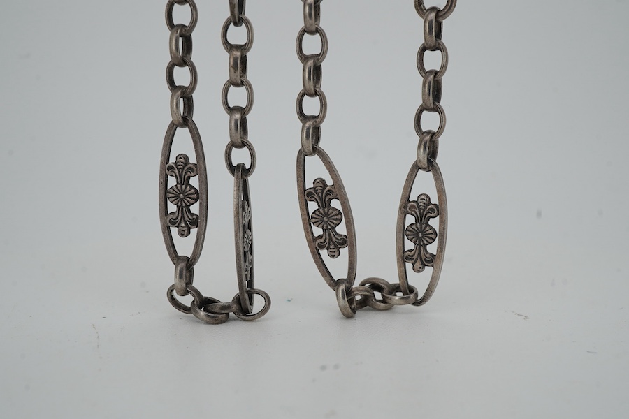 A late 19th/early 20th century silver and amethyst longchain, composed of foliate links and set with cabochon amethysts, length 150cm, stamped 800, maker's mark HY